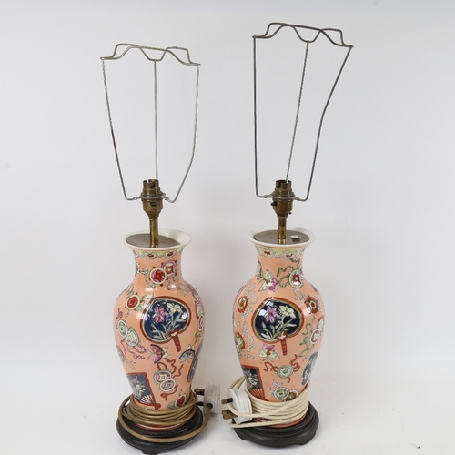 554 - 2 pairs of Oriental porcelain table lamps, on wooden stands, height 63cm overall