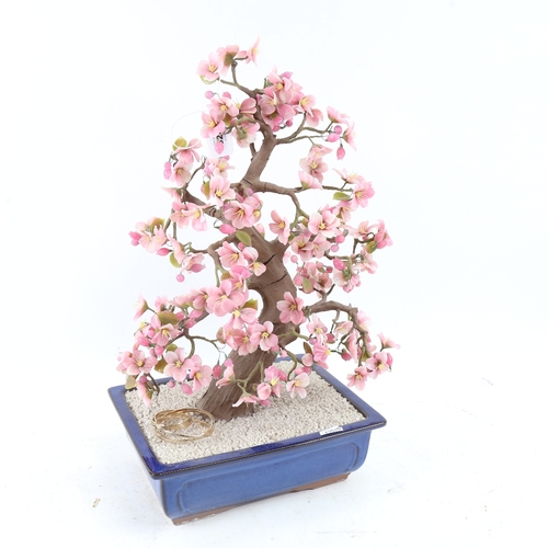 617 - A large scale ornamental tree in jardiniere, with pink glass petals, height 46cm, and a pair of Doul... 