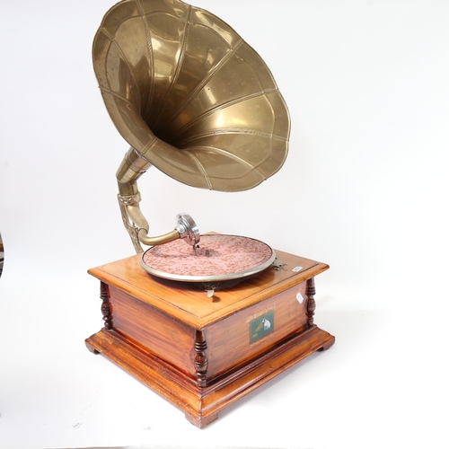 556 - A reproduction wind-up gramophone with brass horn and HMV lithographed label.