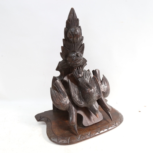 574 - A Black Forest carved wood wall  bracket, supported by 3 birds, height 46cm