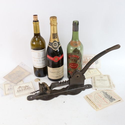 480 - A wall-mounted mechanical brass corkscrew, a bottle of Perrier-Jouet Champagne, various wine labels,... 