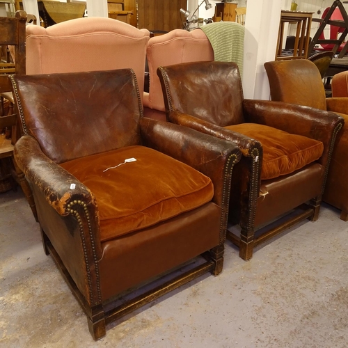 1969 - A pair of early 20th century studded leather-upholstered Club chairs, on stained wood stretchers