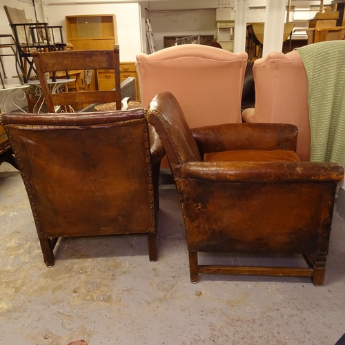 1969 - A pair of early 20th century studded leather-upholstered Club chairs, on stained wood stretchers