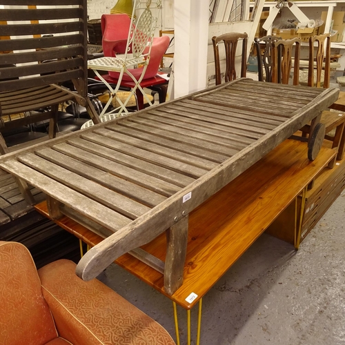 1973 - A teak slatted garden lounger and cushion