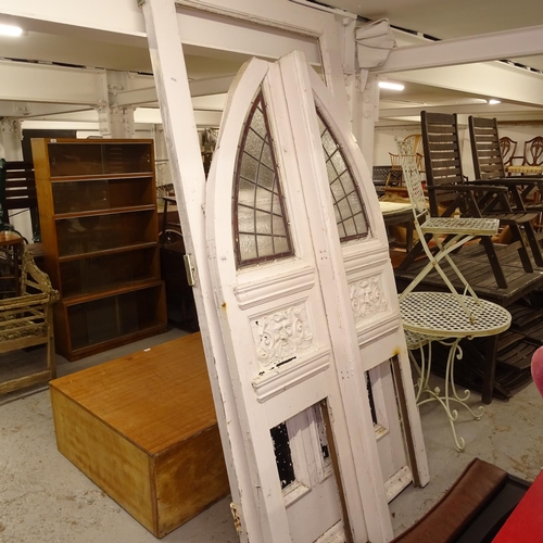 1976 - A pair of Victorian painted arch-top doors, with leadlight coloured glazed panels, and relief carved... 