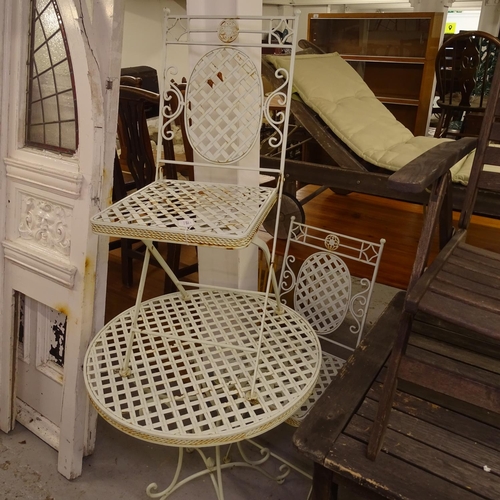 1977 - A painted metal circular garden table, and a pair of matching folding chairs