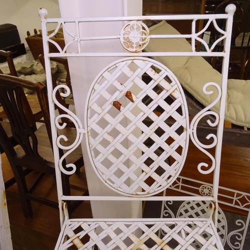 1977 - A painted metal circular garden table, and a pair of matching folding chairs