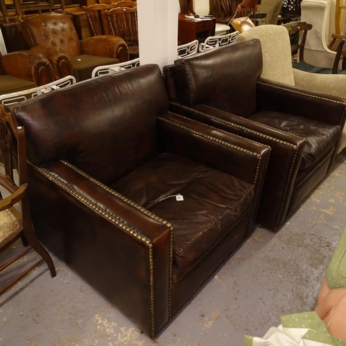 1986 - A pair of brown leather-upholstered and brass-studded armchairs, W86cm, H90cm, seat height 43cm and ... 