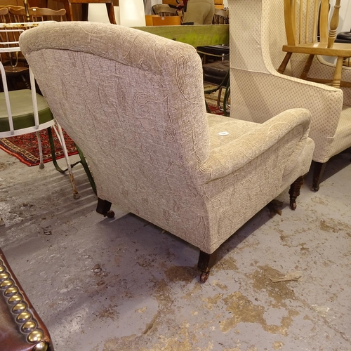 1987 - A Howard style upholstered armchair, on turned mahogany legs