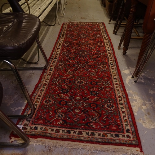 1995 - A red ground Caucasian design runner, 203cm x 68cm