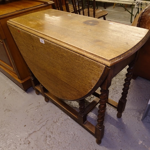 2012 - An oak oval barley twist gateleg table, W88cm