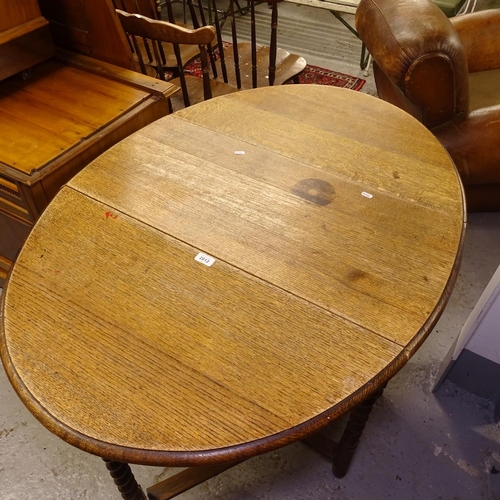 2012 - An oak oval barley twist gateleg table, W88cm