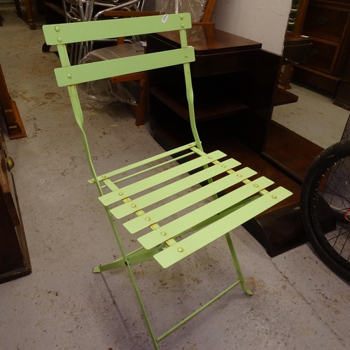 2023 - A green painted metal circular folding garden table, together with a pair of matching folding chairs