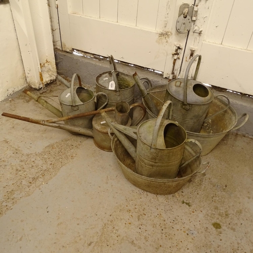 2028 - A collection of galvanised metal watering cans, tin bath etc