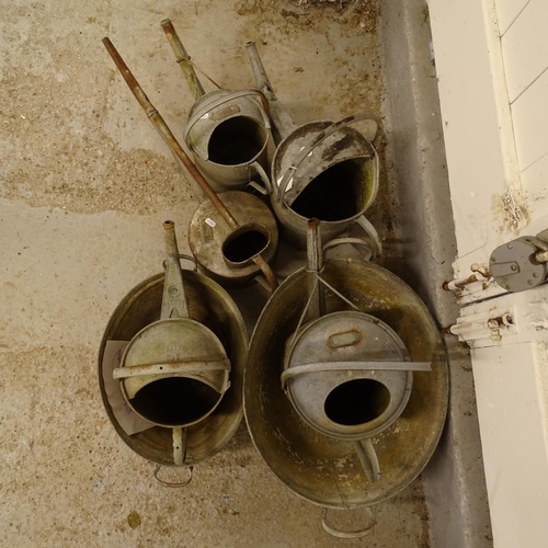 2028 - A collection of galvanised metal watering cans, tin bath etc