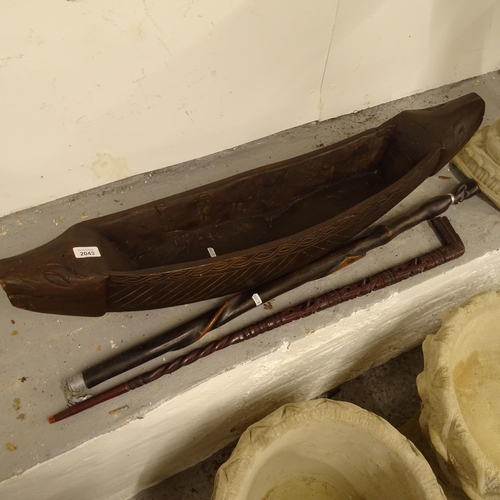 2043 - A hardwood carved trough, and 2 carved hardwood walking sticks