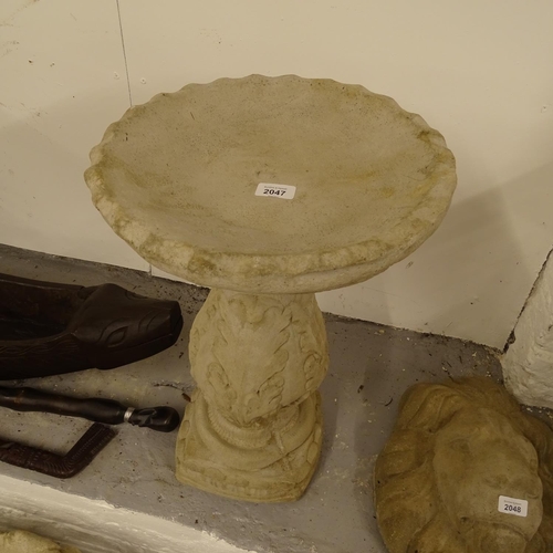 2047 - A concrete 2-section garden birdbath, on acanthus leaf embossed pedestal, W36cm, H60cm