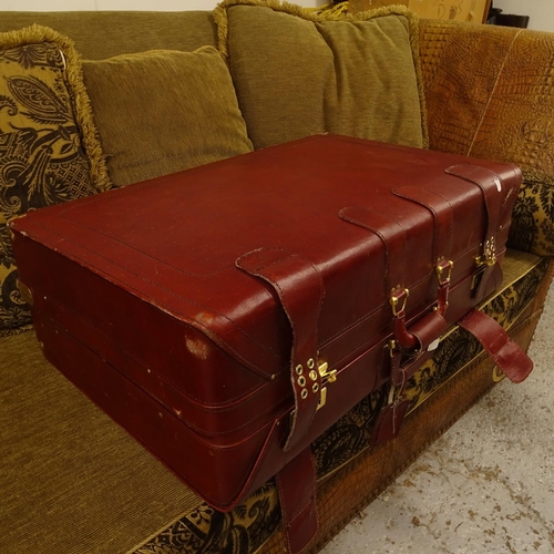 2058 - An Amiet burgundy suitcase, a burgundy leather suitcase, and brown leather holdall