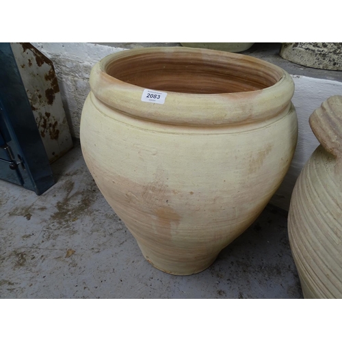 2083 - A terracotta olive oil pot, W45cm, H57cm