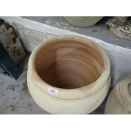 2083 - A terracotta olive oil pot, W45cm, H57cm