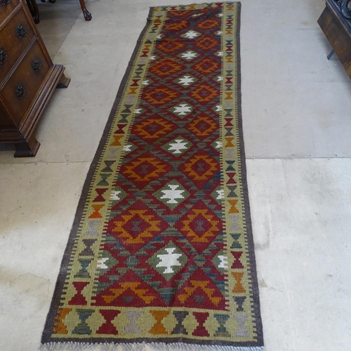 2091 - A Mamainer red ground runner, 298cm x 82cm