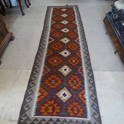 2092 - A red ground Kilim runner, 325cm x 87cm