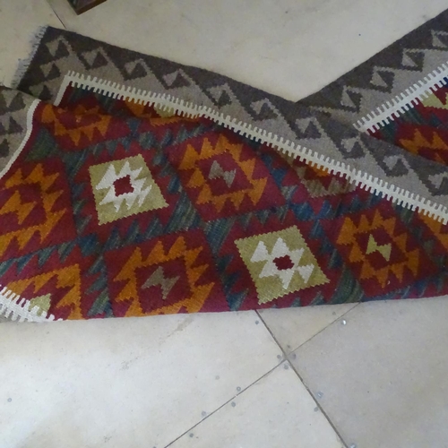 2092 - A red ground Kilim runner, 325cm x 87cm