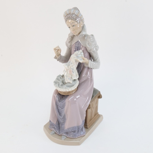 522 - A Lladro porcelain figure of a woman sewing, height 29cm