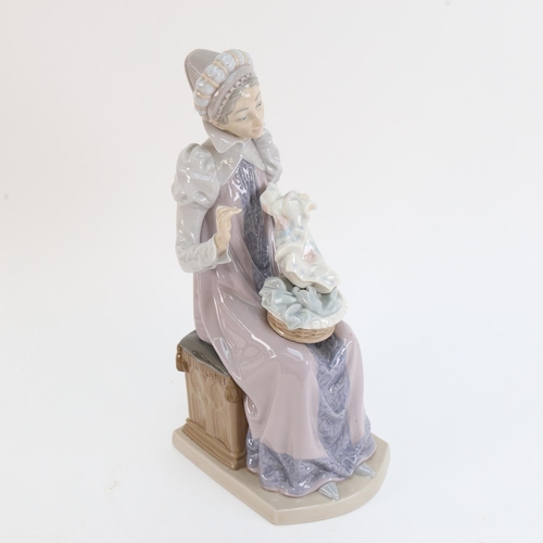 527 - A Lladro porcelain figure of a woman sewing, height 29cm