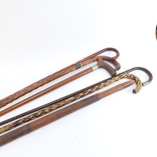 534 - A Tribal hardwood club with painted animals, length 81cm, and a group of Vintage walking canes (6)