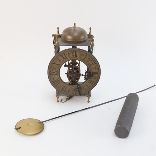 553 - A brass-framed lantern style clock, with weight and pendulum, height 22cm