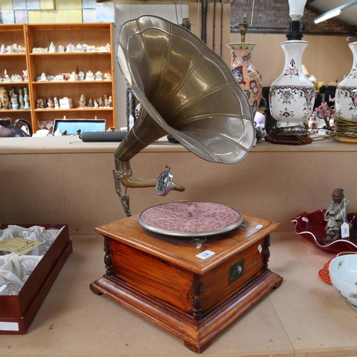 556 - A reproduction wind-up gramophone with brass horn and HMV lithographed label.