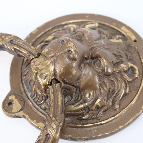 558 - A large relief cast brass lion mask door knocker, overall height 34cm, width 20cm