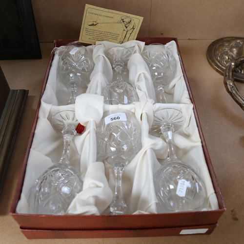 560 - A boxed set of crystal wine glasses