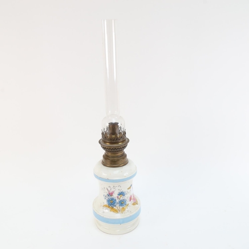 561 - A Vintage ceramic oil lamp with chimney, 47.5cm