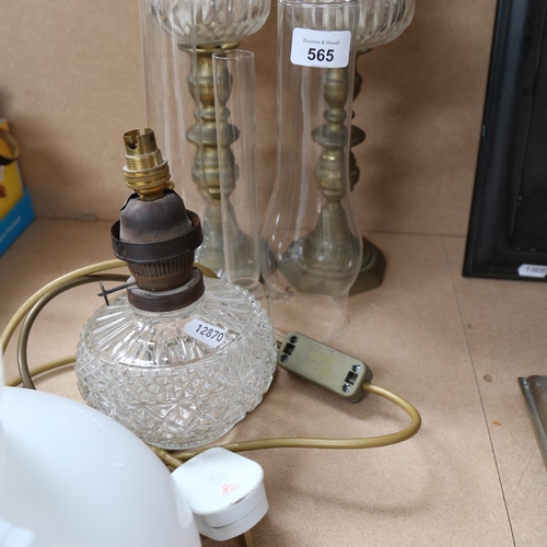 565 - A pair of cut-glass and brass oil lamps, with chimneys and shades, and another