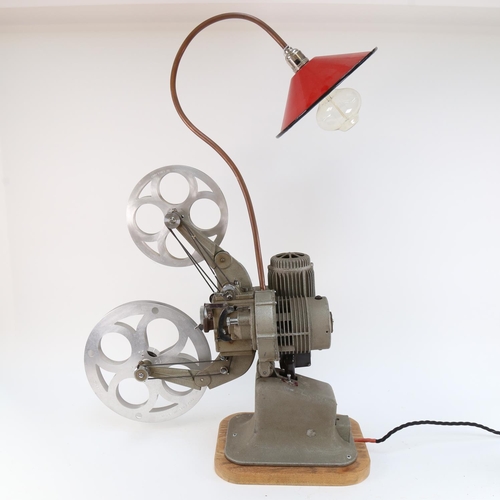 573 - A Vintage electric film projector, complete with lamp with red enamel shade