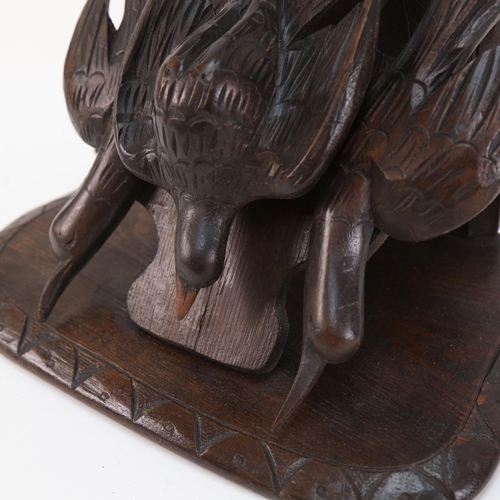 574 - A Black Forest carved wood wall  bracket, supported by 3 birds, height 46cm