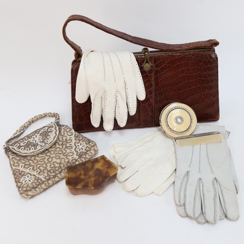 586 - A leather handbag, an evening purse, a compact, gloves etc