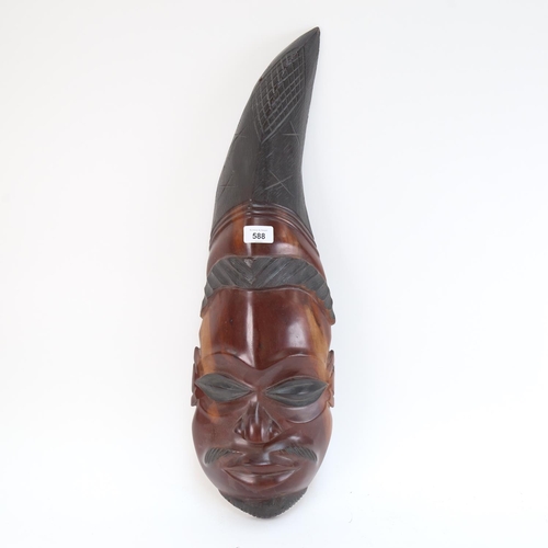 588 - A carved African Tribal head, 65cm