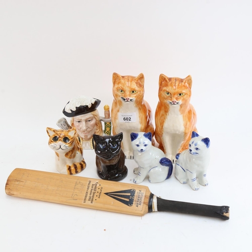 602 - Babbacombe Pottery cats, height 21cm, blue faience cats, a 1981 Test Series miniature cricket bat et... 