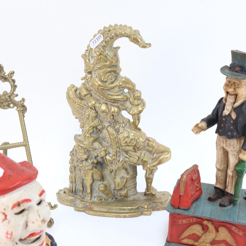 606 - A brass Mr Punch doorstop, 29cm, 2 novelty cast-iron money boxes, and a small picture easel