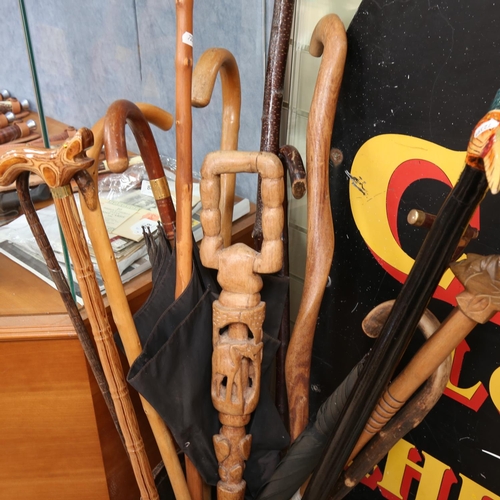 655 - A collection of walking sticks, in Vintage stand