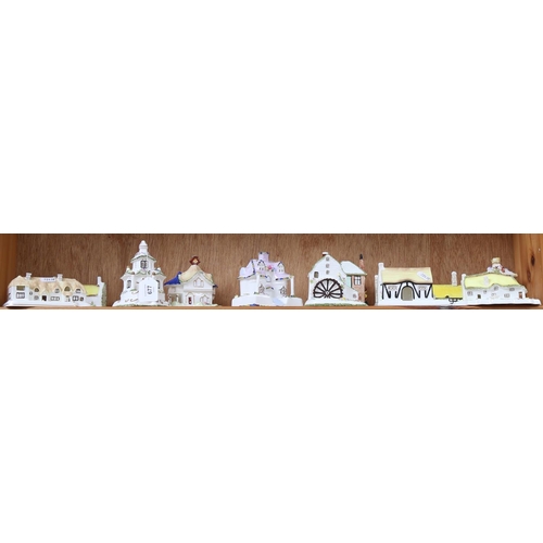 677 - A shelf of 11 Coalport Cottages, boxed