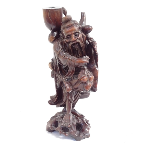 544 - A Chinese carved rootwood lamp base in the form of a travelling man, early to mid-20th century, heig... 