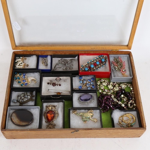 857 - A small table-top jewellery display cabinet, a quantity of costume brooches and necklaces