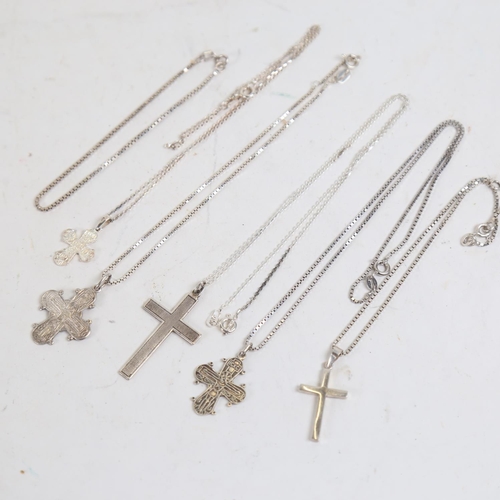 877 - 5 various silver crucifixes and chains, and a silver bracelet