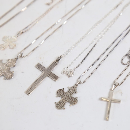 877 - 5 various silver crucifixes and chains, and a silver bracelet