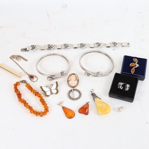 909 - 2 silver bangles, an amber ring, amber set pendants etc