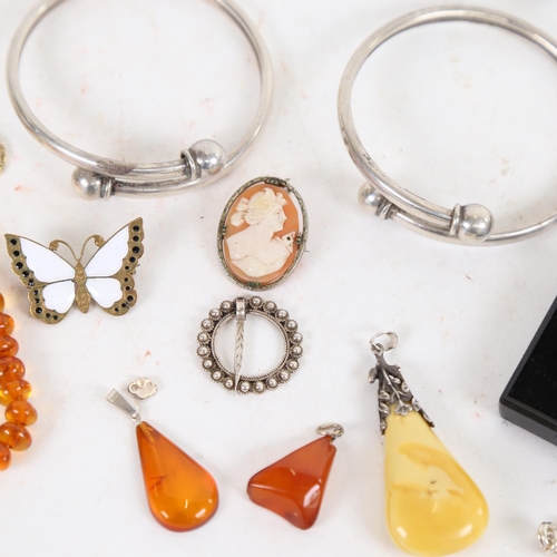 909 - 2 silver bangles, an amber ring, amber set pendants etc